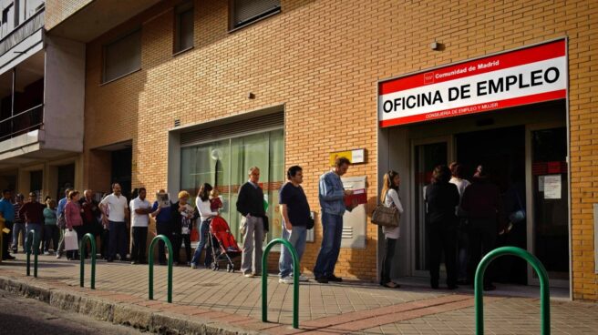 Desempleados españoles hacen cola en una oficina de empleo.