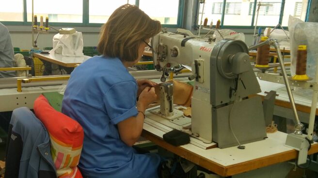 Una mujer trabaja en una fábrica de zapatos de Elche