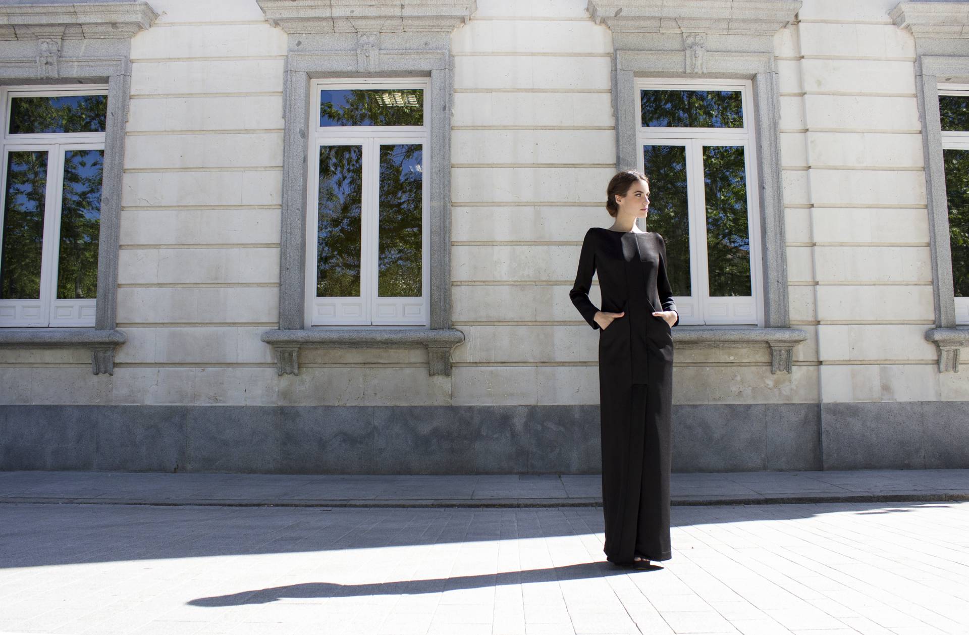 Vestido largo de neopreno con cortes verticales delanteros que finalizan en una abertura original, estilizando la figura y que contrastan con relevantes bolsillos para aportar aun más modernidad, de Impúribus.