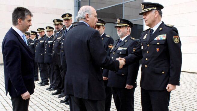 Jorge Fernández Díaz, entonces ministro del Interior, estrecha la mano a Eugenio Pino en presencia de Ignacio Cosidó en un acto de la Policía.