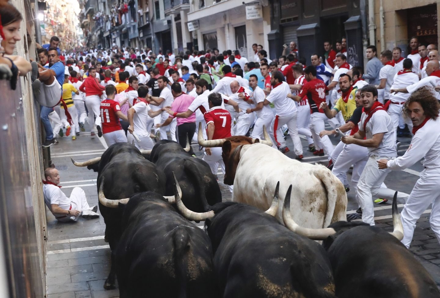 Los toros de la ganadería de Victoriano del Río llegan a la curva de Mercaderes de Pamplona, durante el sexto encierro de San Fermín 2017.