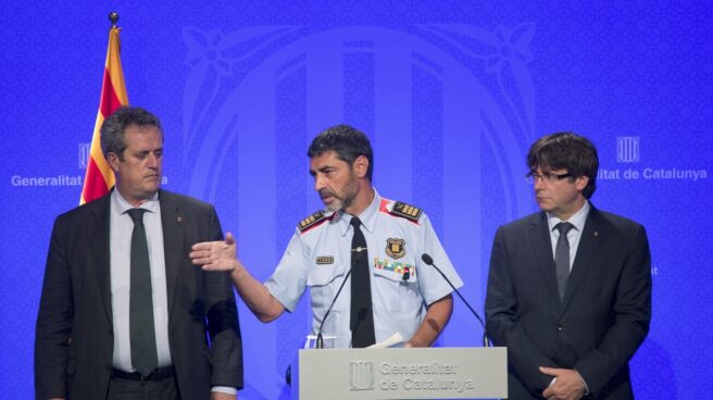 El presidente catalán, Carles Puigdemont (d), junto al conseller de Interior, Joaquim Forn (i), y el mayor de los Mossos d'Esquadra, Josep Lluís Trapero.