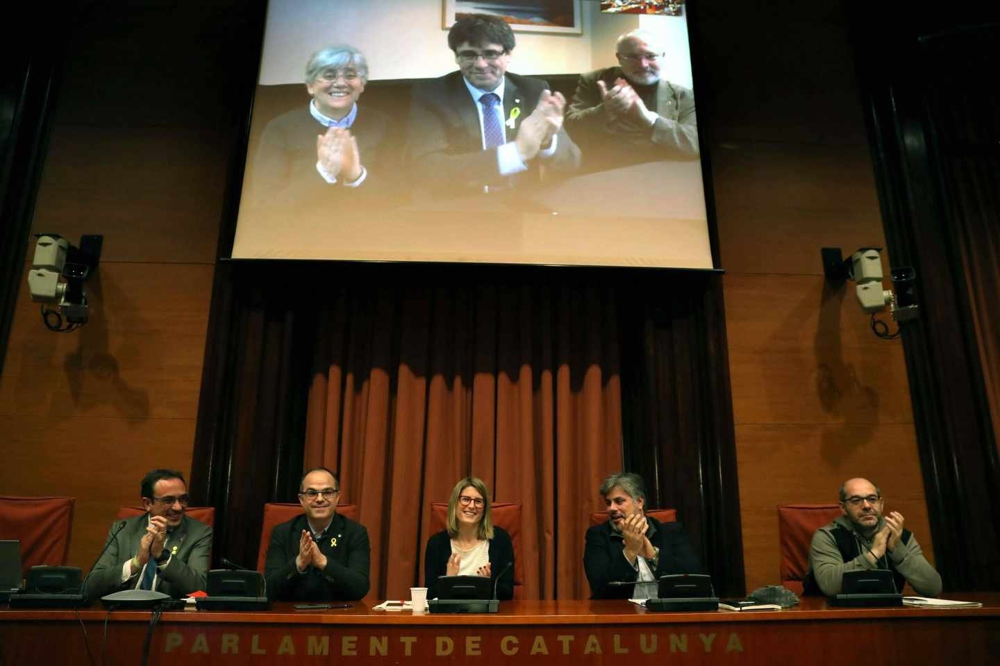 Los diputados electos Carles Puigdemont (c), Clara Pontasí (i) y Lluís Puig (d), participaron telemáticamente desde Bruselas en una reunión.