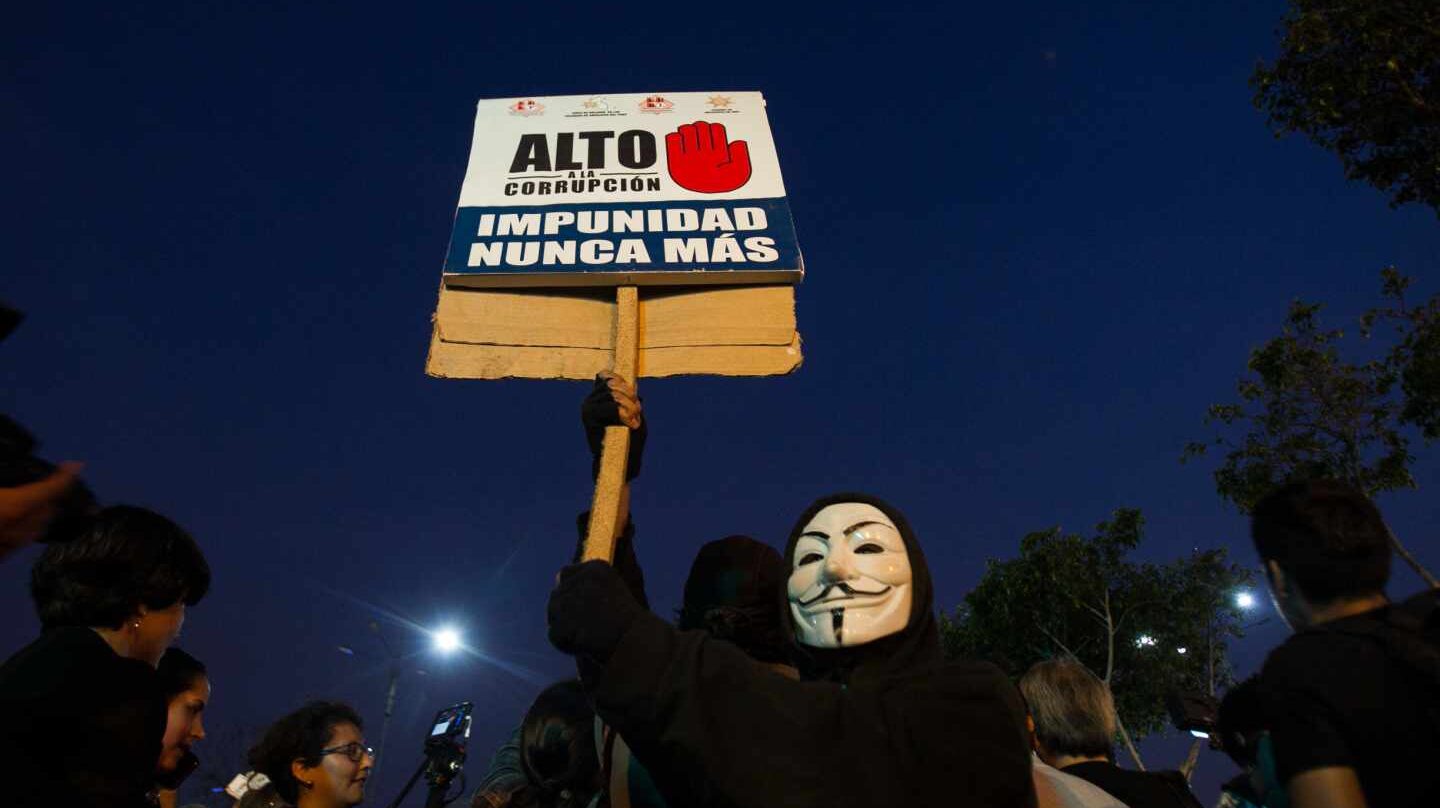 Un manifestante muestra un cartel contra la corrupción política en Lima.