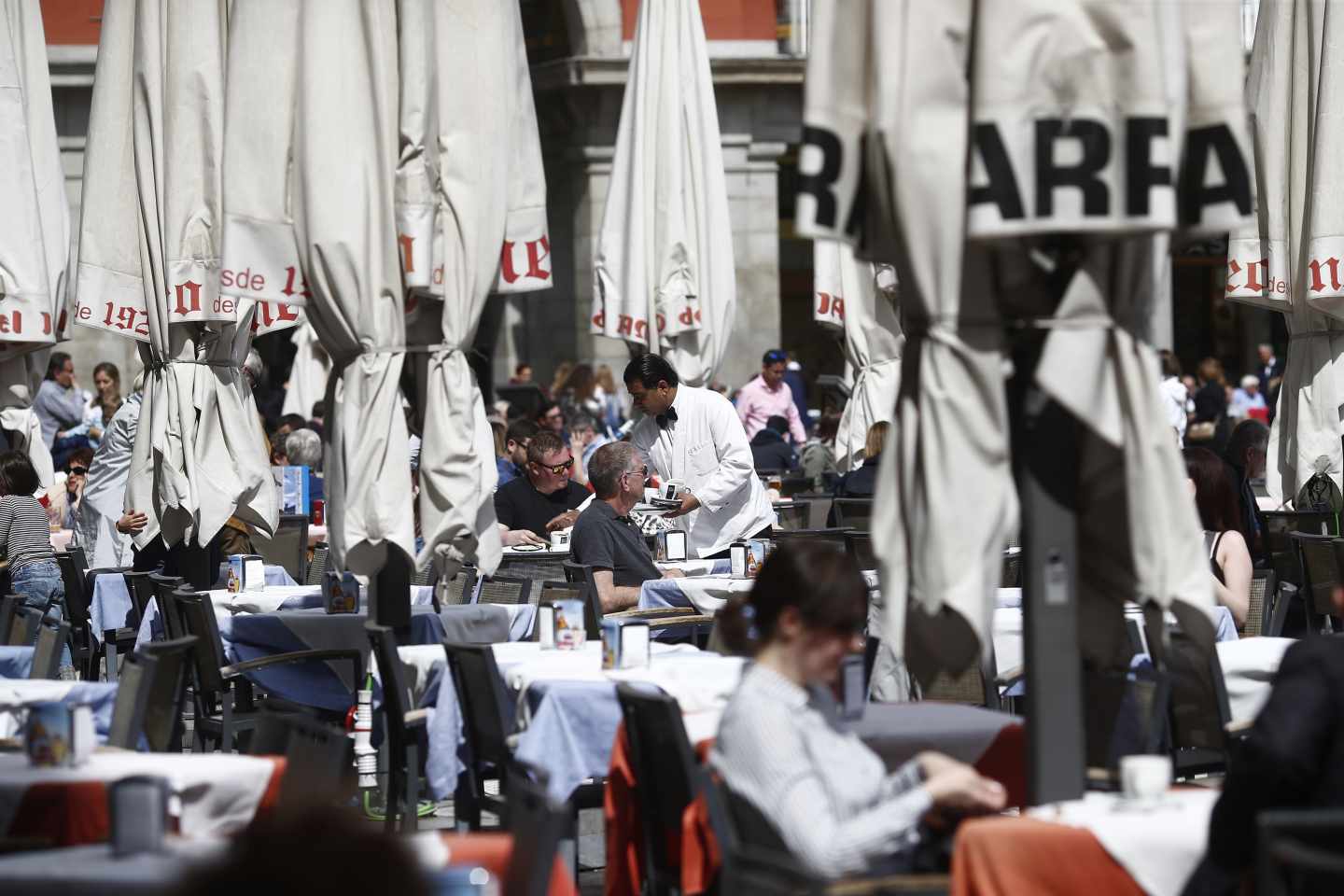 Un camarero trabaja en una de las terrazas de la Plaza Mayor de Madrid.