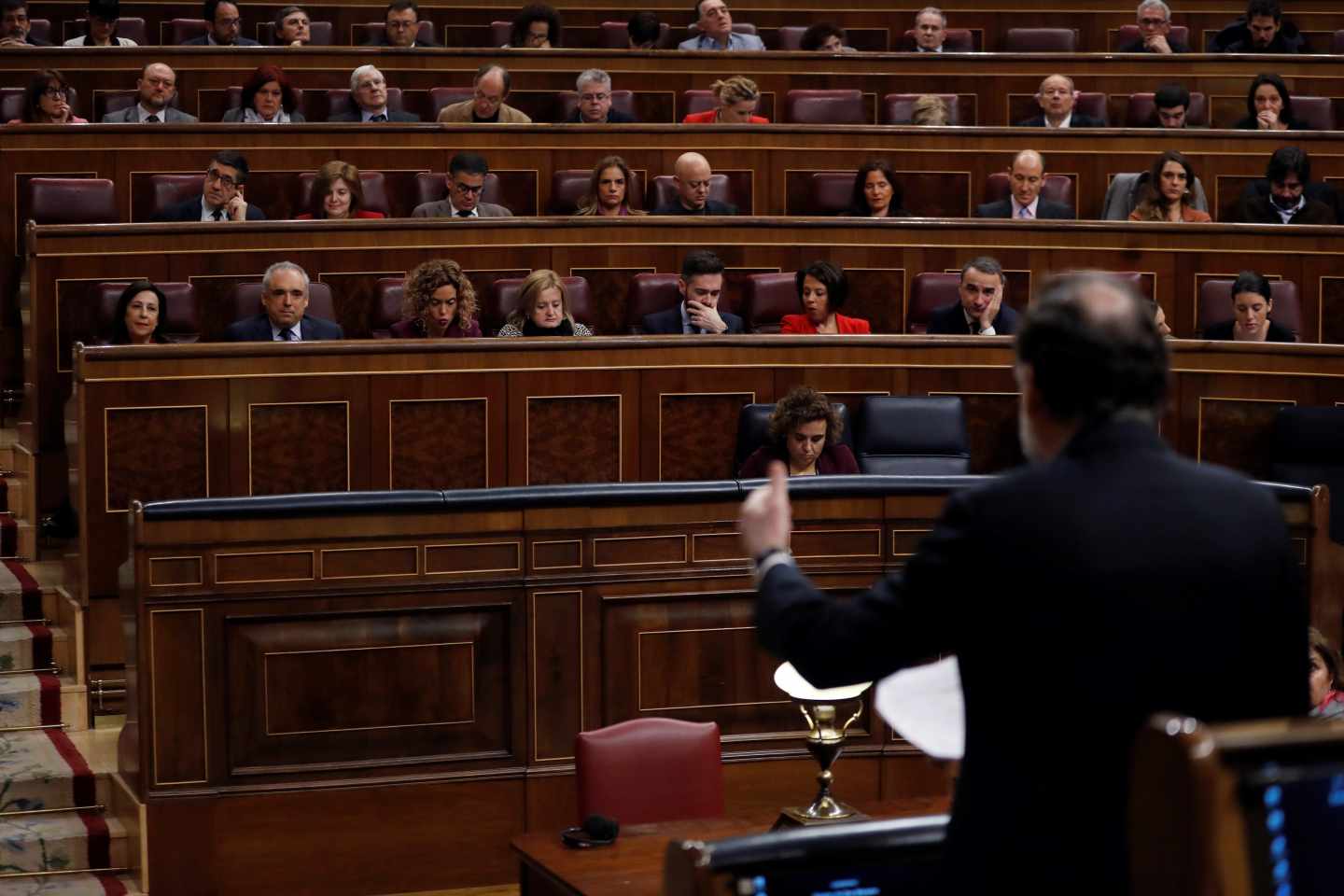 El presidente del Gobierno, Mariano Rajoy, de espaldas, durante su intervención en la sesión de control del Congreso.