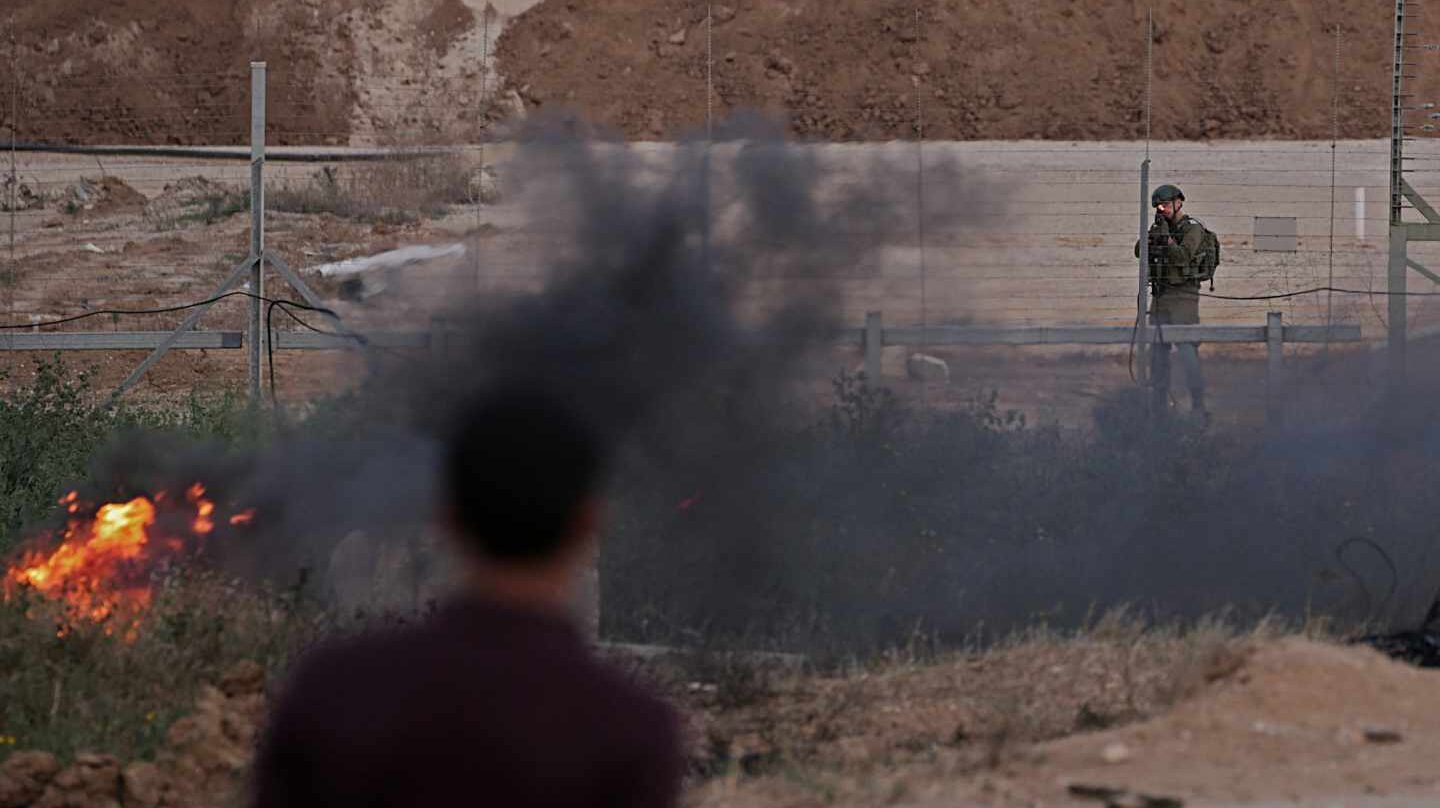 Un soldado israelí apunta a los manifestantes palestinos hoy, martes 3 de abril de 2018, durante los enfrentamientos con las tropas israelíes a lo largo de la frontera entre Israel y la Franja de Gaza, en el este de la Franja de Gaza. Los manifestantes planean reclamar el derecho de los refugiados palestinos en Medio Oriente a regresar a los hogares de los que huyeron en la guerra que rodeó la creación de Israel en 1948. EFE