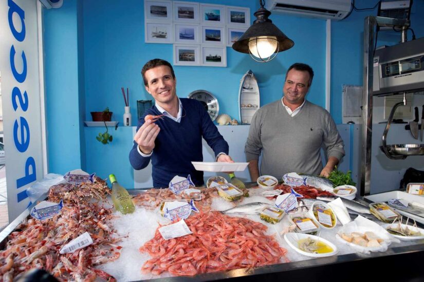 Pablo Casado enseña a cámara unas quisquillas durante una visita electoral a Motril.