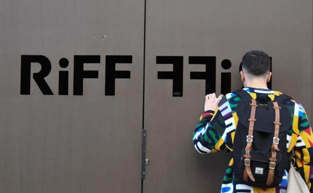 Un joven se asoma a las puertas del restaurante Riff de Valencia.