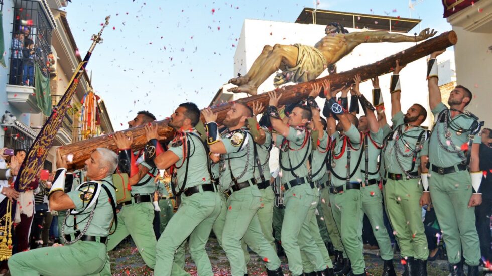 Un grupo de legionarios levanta al Cristo de Mena en Málaga.