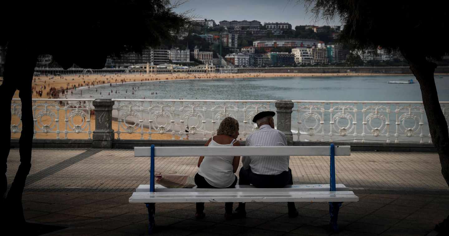 Una pareja descansa en un banco en la playa de La Concha, en San Sebastián, este lunes.