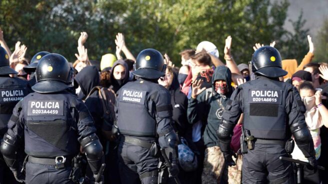 Agentes de Mossos d'Esquadra desalojan a manifestantes que cortaban el tráfico durante las protestas de Cataluña.