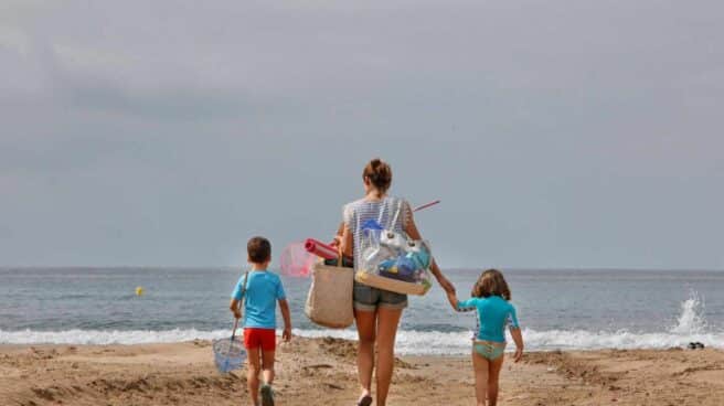 Una familia llega a la Playa de Levante, de Salou.
