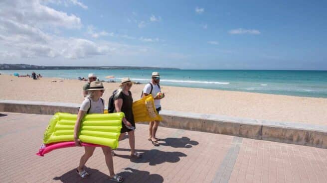 Turistas caminan por el paseo de la playa en Palma de Mallorca. Turistas caminan por el paseo de la playa en Palma de Mallorca.