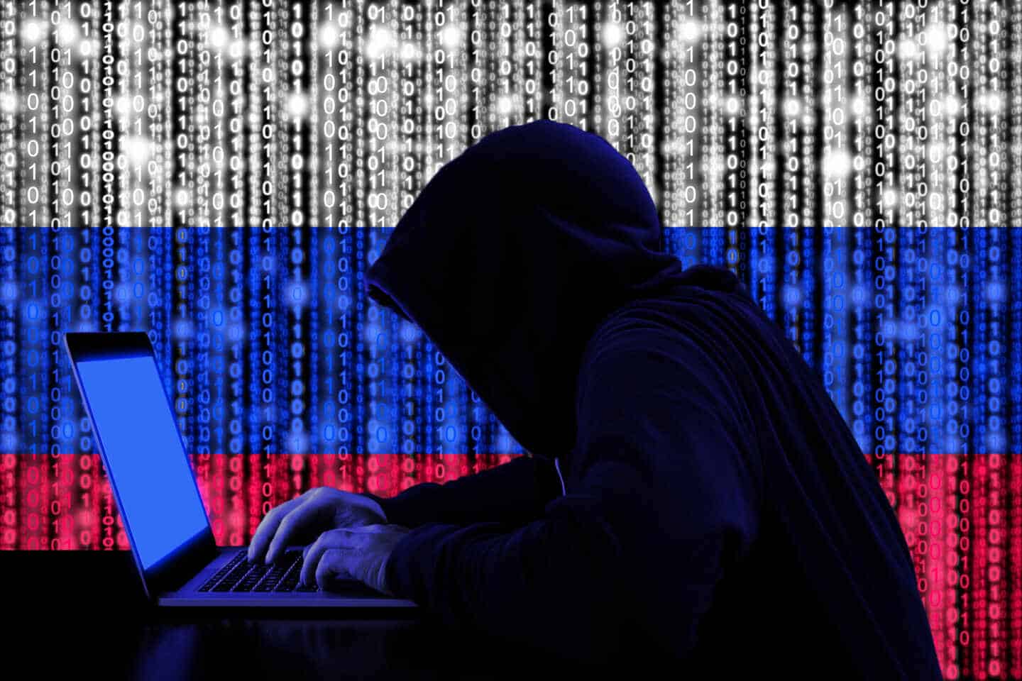 Un hacker delante de una bandera de Rusia formada por un código binario.