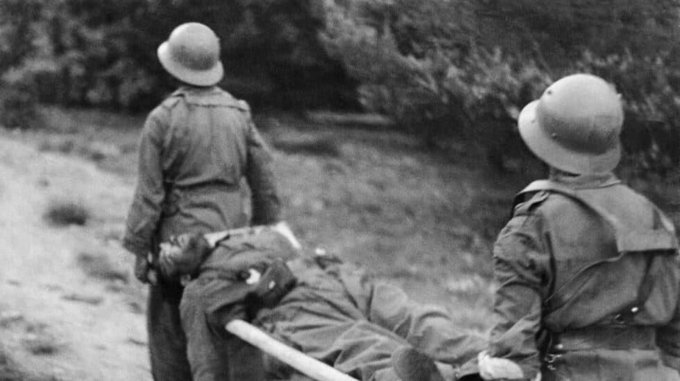 Dos hombres portan un herido foto de Gerda Taro realizada en la Guerra Civil