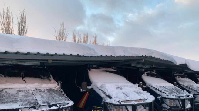 Vehículos de la UIP de Madrid, cubiertos de nieve este fin de semana en la base de Moratalaz (Madrid).