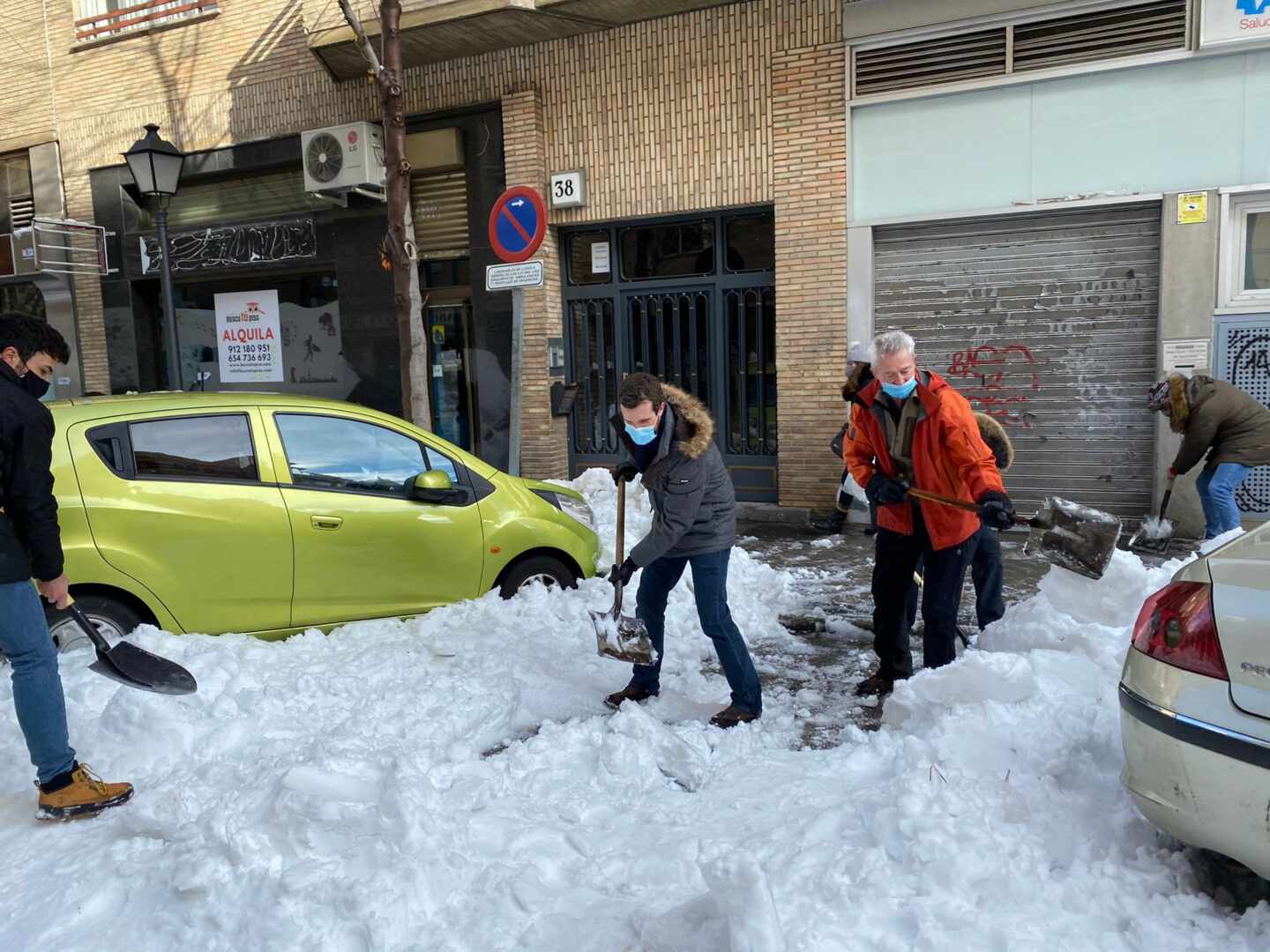 Pablo Casado retira nieve de la entrada de un centro de salud.