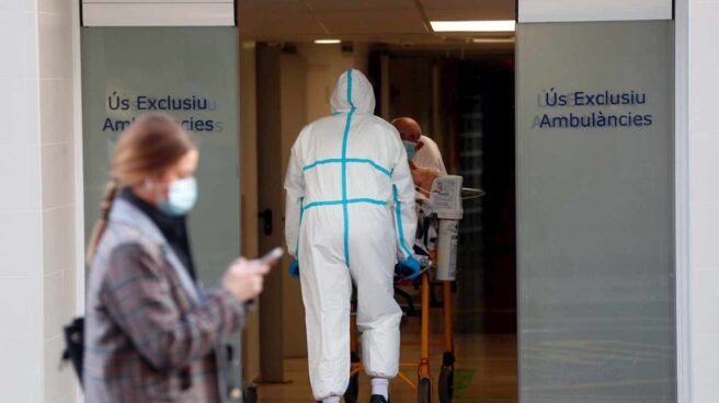 Un sanitario traslada a un enfermo en el Hospital Clínico de Valencia.