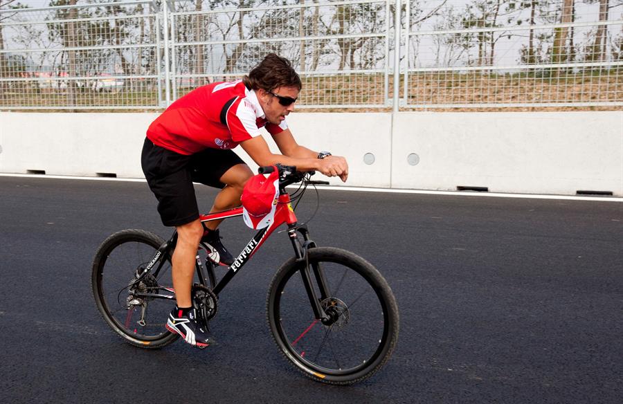 Fernando Alonso monta en bicicleta en un circuito de Fórmula 1 en Seúl.
