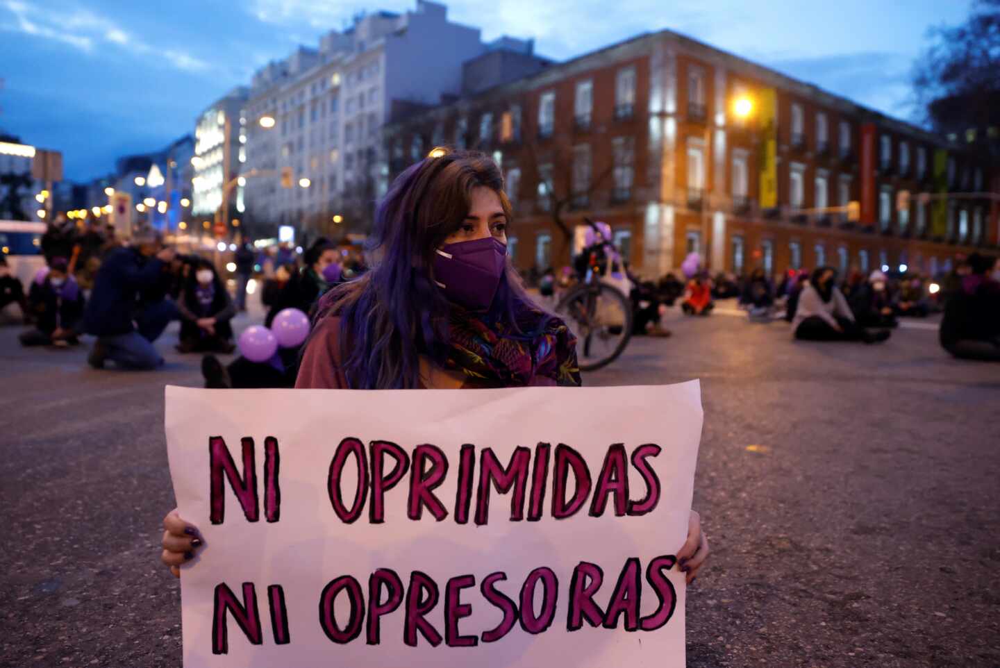 Asistentes a una sentada improvisada en la plaza de Neptuno de Madrid con motivo de la celebración del Día Internacional de la Mujer.