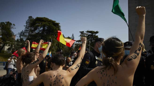 Activistas de Femen con águilas franquistas dibujadas en la espalda durante un acto por el Día de la Victoria, en Madrid