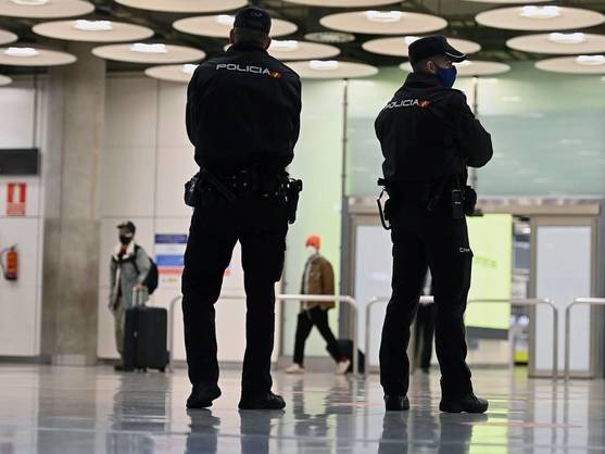 Dos policías en el aeropuerto de Barajas intentando encontrar delitos en el aeropuerto.