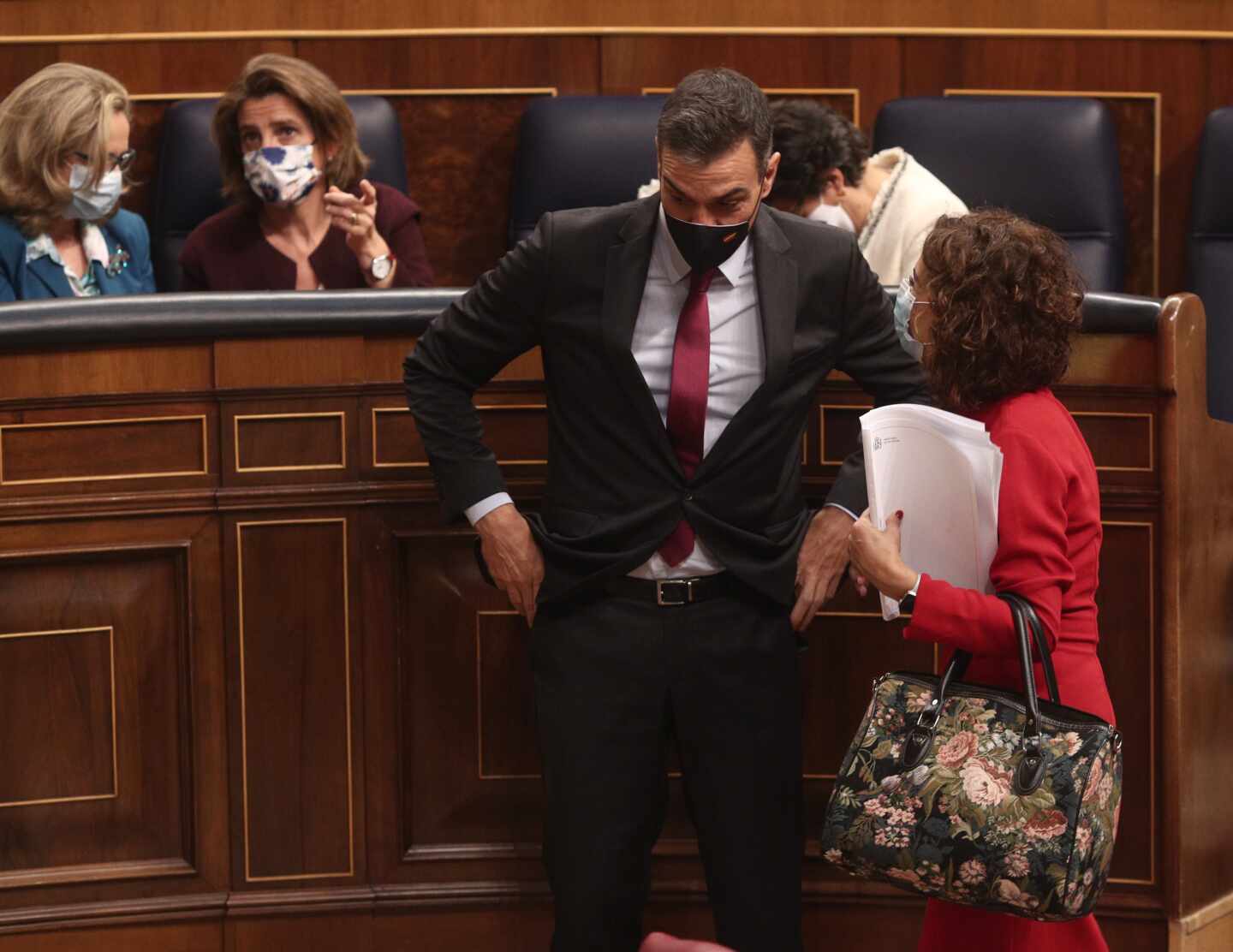 El presidente del Gobierno, Pedro Sánchez, habla con la ministra de Hacienda y portavoz del Gobierno, María Jesús Montero, en el Congreso de los diputados.