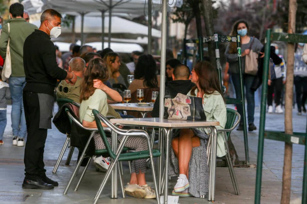 Varias personas conversan en una terraza de Madrid.