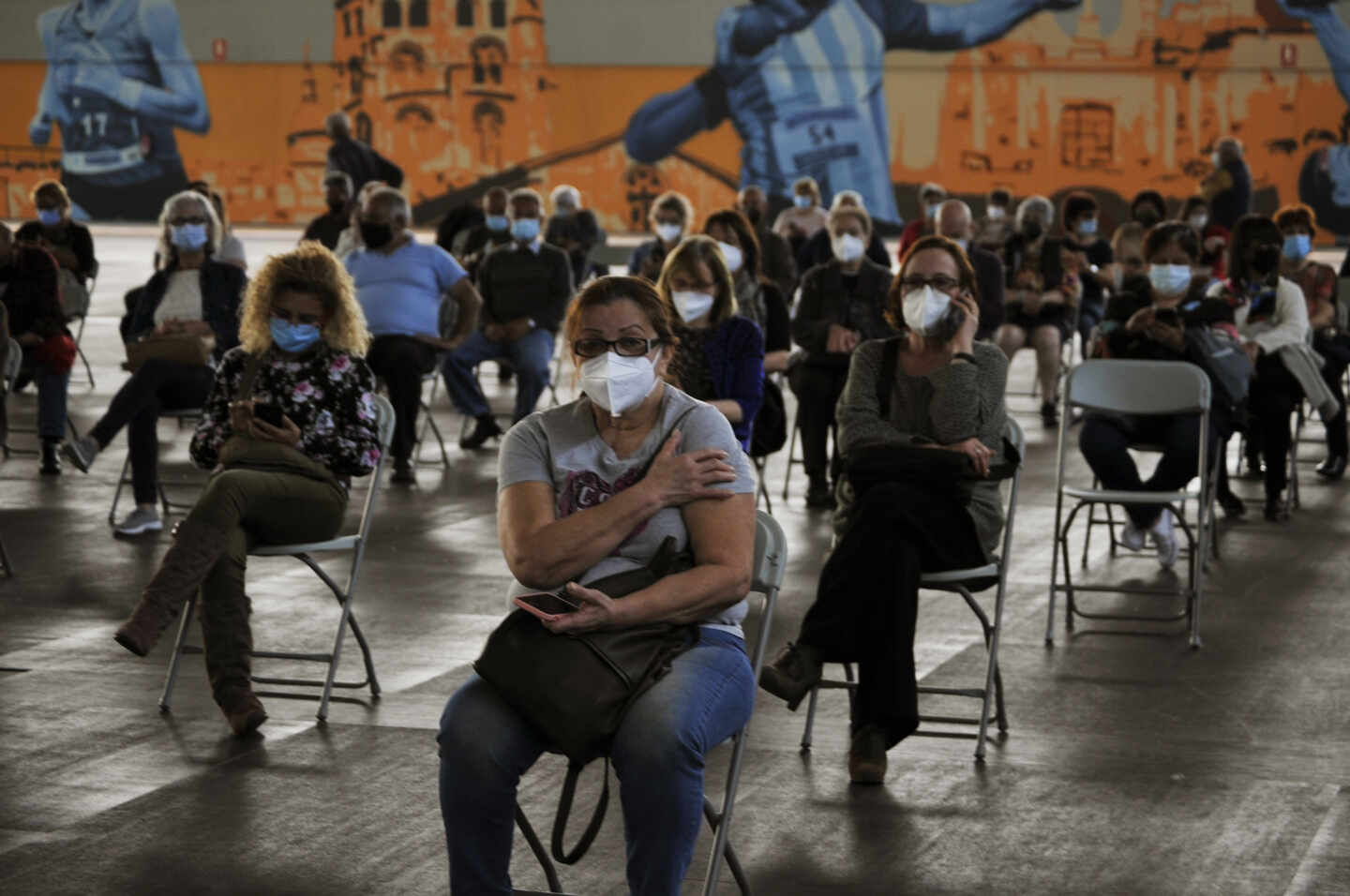 Fila de pacientes que esperan sentados tras recibir la primera dosis de la vacuna AstraZeneca en el recinto de Expourense, a 6 de abril de 2021, en Ourense