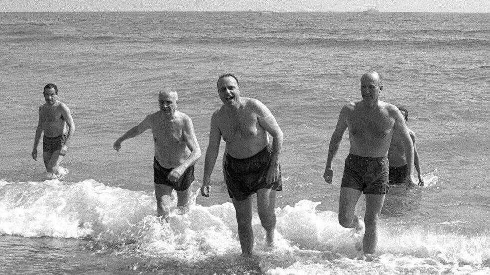 Foto de archivo de 1966 del ministro de Información y Turismo, Manuel Fraga (2-d), y el embajador de EEUU en España, Angier Biddle Duke (d), bañándose en la playa de Palomares, en Almería.