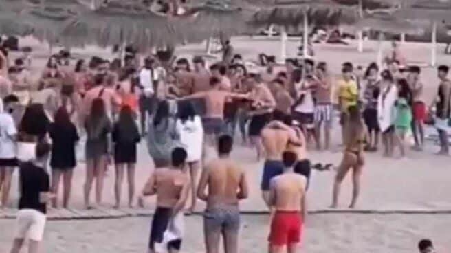 Varios jóvenes participan en una pelea con guantes de boxeo en una playa de Adeje, Tenerife.