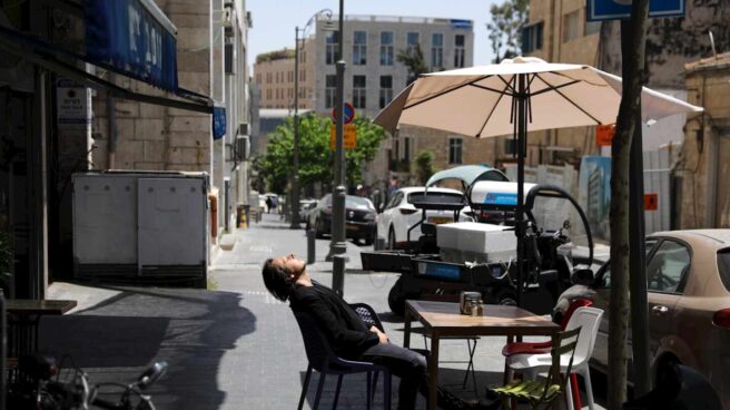 israel-efectividad-vacunas-covid Un hombre sentado sin mascarilla en una terraza al aire libre en Jerusalén, días después de que el país eliminara el uso obligatorio de Mascarilla.