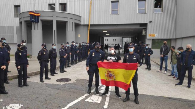 Ángel H.S., de paisano tras la bandera, durante la despedida en la comisaría coruñesa de Lonzas.