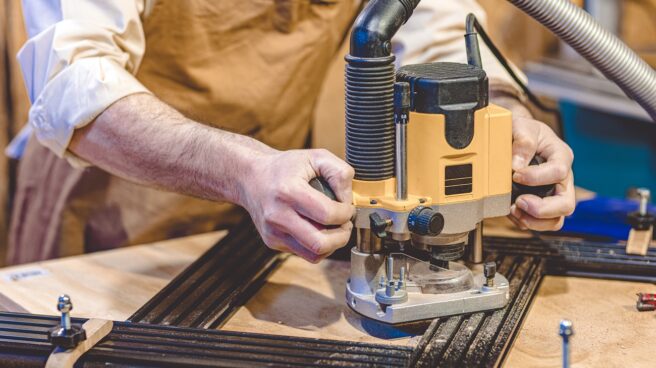 detail-of-carpenter-using-router-with-an-adjustable-template