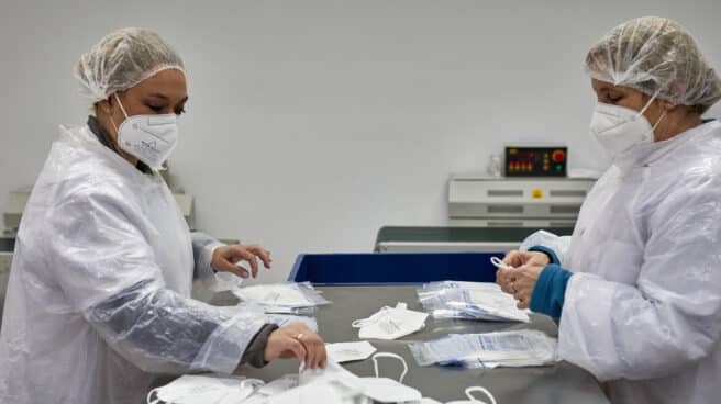 Dos operarias, en una planta de producción de mascarillas FFP2 en Madrid.