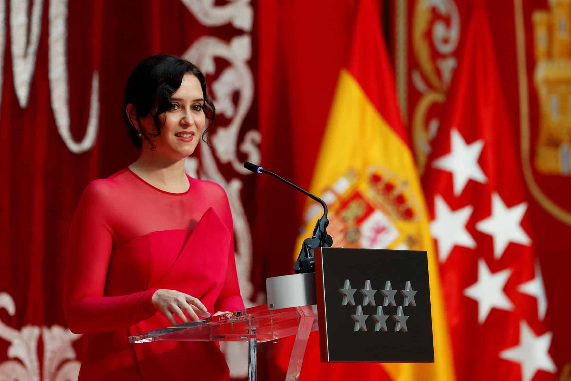 La presidenta de la Comunidad de Madrid, vestida de rojo fucsia, en su toma de posesión.