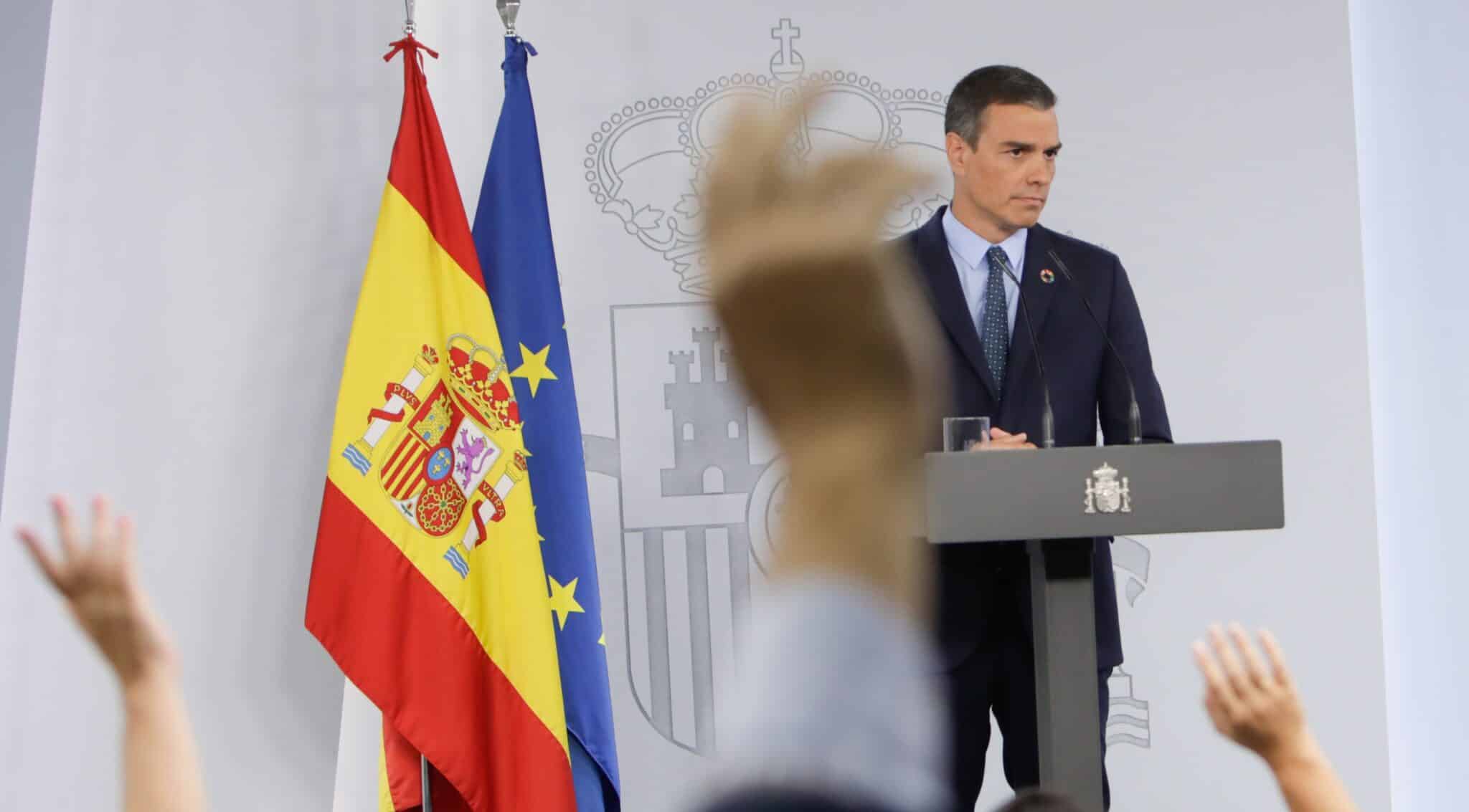 Periodistas levantan la mano para preguntar en una comparecencia de Pedro Sánchez en La Moncloa.