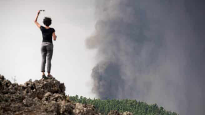 Una mujer fotografía el volcán con el móvil