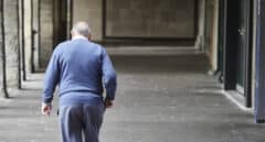 Un hombre mayor camina por una galería en el centro de Pamplona.