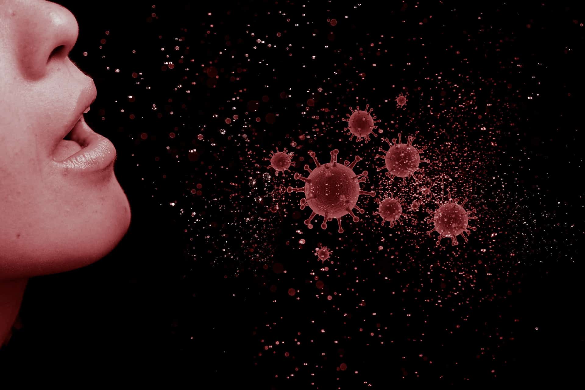 Imagen de archivo de unapersona estornudando e ilustración de virus en el aire