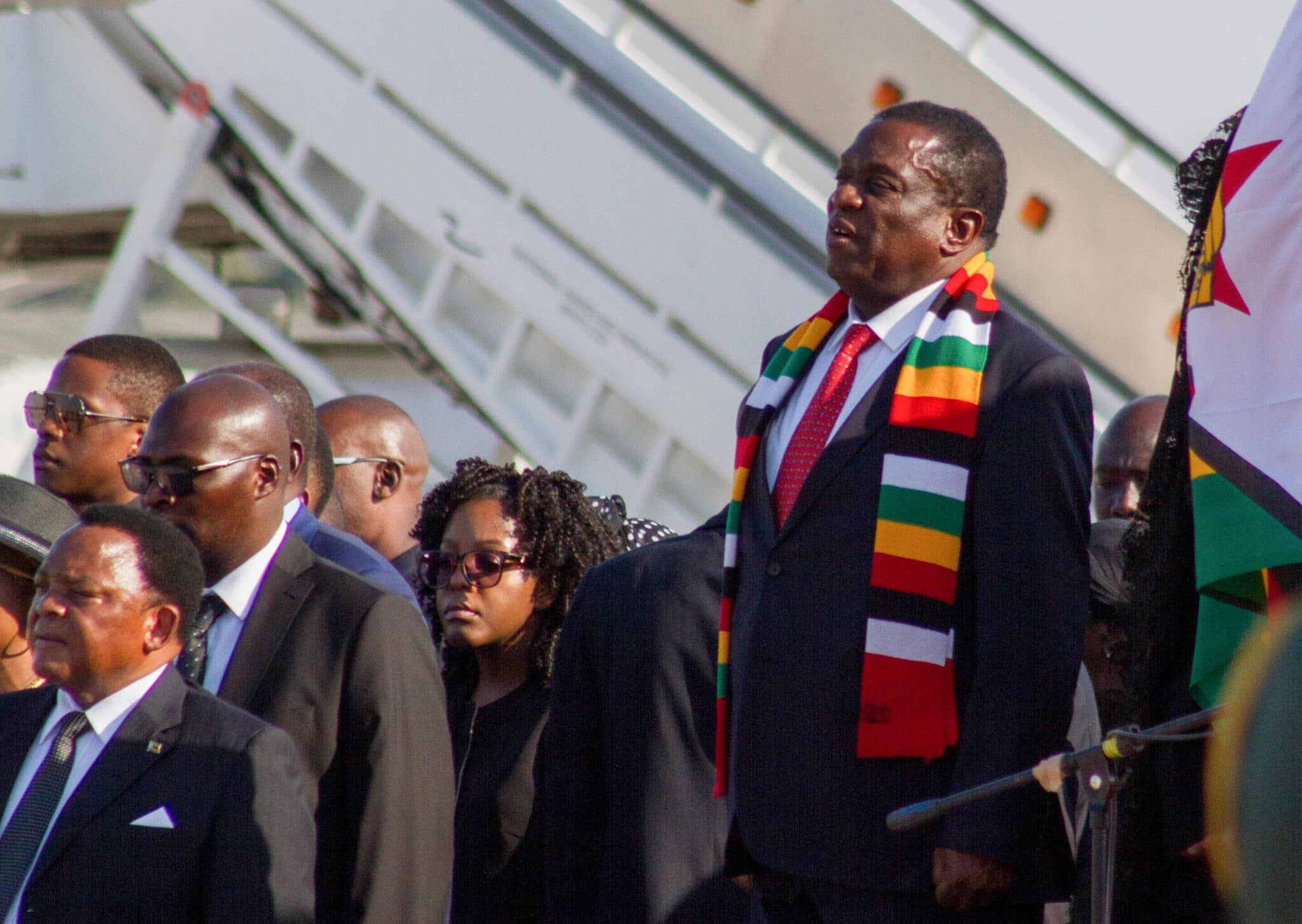 El presidente de Zimbabwe, Emmerson Mnangagwa (R), se encuentra durante la llegada del ataúd del ex presidente de Zimbabwe, Robert Mugabe