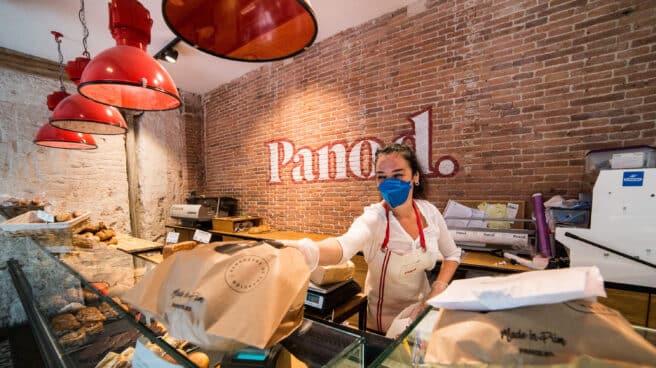 Una trabajadora de la panadería Panod atiende a un cliente.