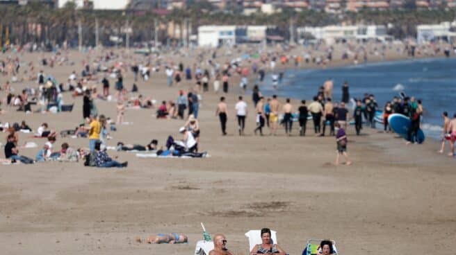 Varias personas toman el sol este viernes en la playa de Las Arenas de Valencia disfrutando de las temperaturas inusualmente altas
