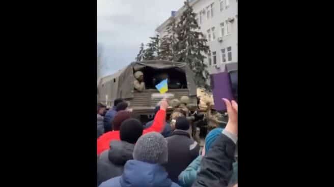 Ciudadanos muestran banderas de Ucrania y gritan contra Putin mientras los soldados rusos se montan en camiones en Berdiansk. Ciudadanos muestran banderas de Ucrania y gritan contra Putin mientras los soldados rusos se montan en camiones en Berdiansk.