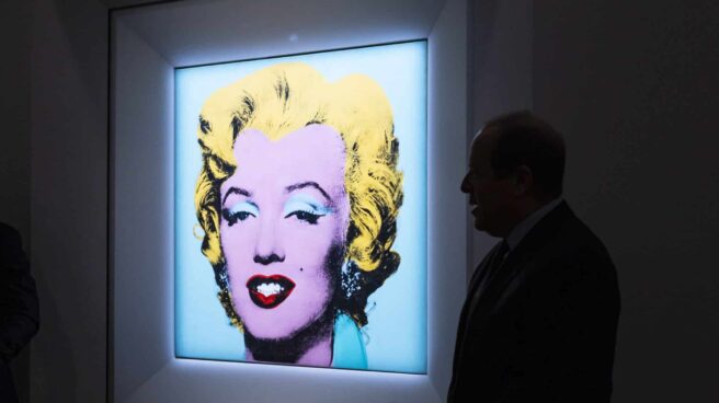 El presidente de Christie's Americas, Marc Porter, posa delante del cuadro de 1964 'Shot Sage Blue Marilyn' de Andy Warhol