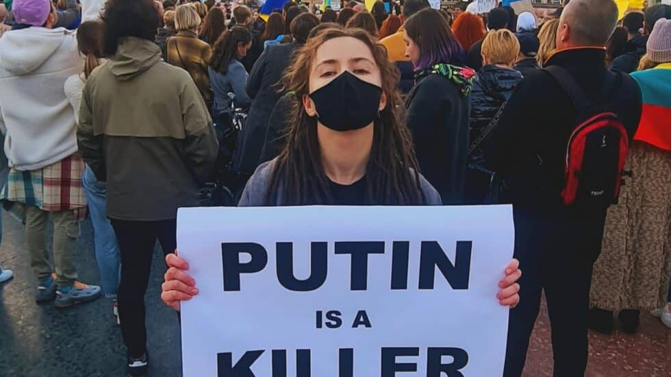 Alisa Sibirskaya, una joven rusa afincada en Barcelona, con una pancarta que reza "Putin es un asesino".