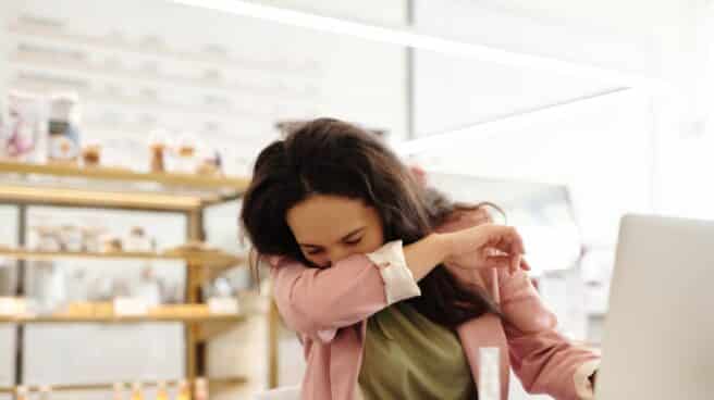 Mujer estornudo Mujer estornudando por alergia o un catarro