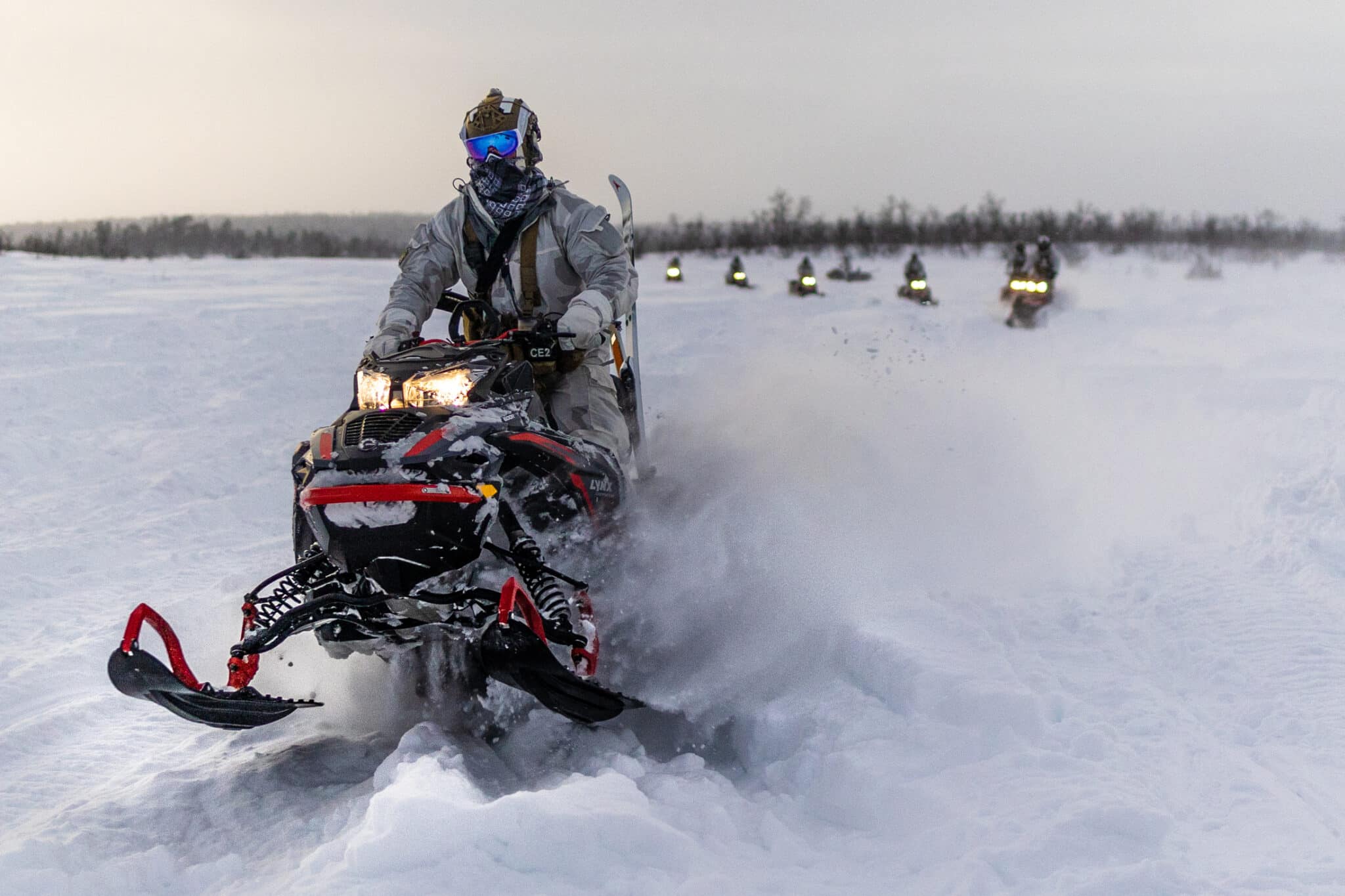 US Army Special Forces soldiers assigned to 10th Special Forces Group drive snowmobiles to navigate the deep snow of the Swedish Arctic on 23 February 2022.