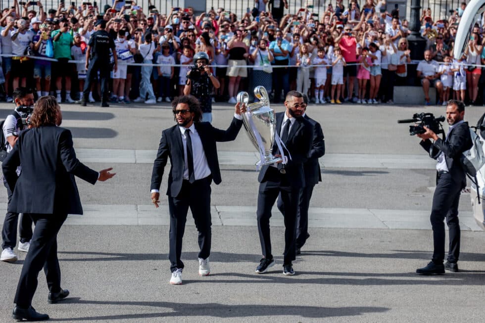 El capitán del Real Madrid Marcelo (2i) y el delantero del Real Madrid Karim Benzema (2d) sostienen la copa a su llegada a la celebración de la victoria del Real Madrid de la Champions League 2022